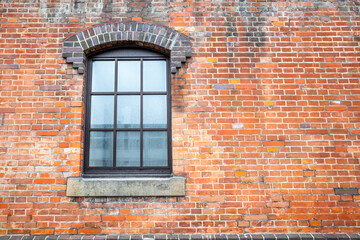 Orange brick wall with classic rectangle style window for background
