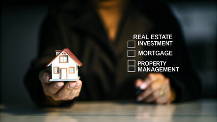 Hand holding house with checklist real estate investment mortgage and proper management concept