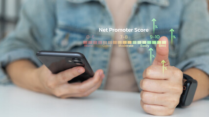 Businessman holding smartphone with Net Promoter Score NPS concept and thumbs up. Customer satisfaction, loyalty, feedback, survey, rating, and business analytics.