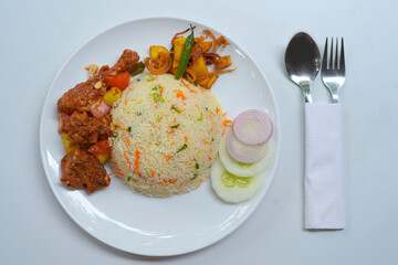 Fried Rice with Hot Devil Chicken and Fresh Onion and Cucumber Garnish.