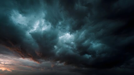 Obraz premium Dramatic dark storm clouds fill the turbulent sky hinting at an impending heavy rain and showcasing the raw power of nature s weather