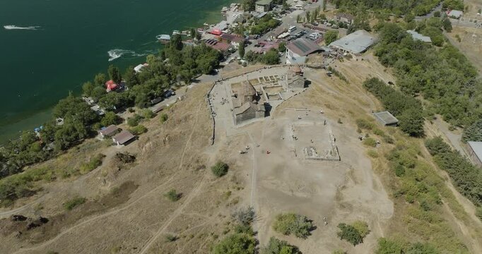 Aerial view of the ancient Sevanavank Monastery atop a hill overlooking the turquoise waters of Lake Sevan, Gegharkunik Province, Armenia.