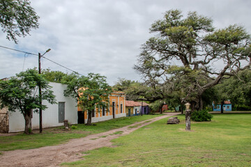 Fototapeta premium Rural village street with colonial houses and trees