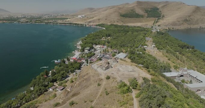 Aerial view of Sevanavank monastery perched atop a hill, contrasting with Lake Sevan's blue waters and the lush greenery, Lake Sevan, Gegharkunik Province, Armenia.