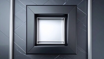 Minimalist square mirror elevated within larger frame on grey surface with blurred plant and cylindrical object in soft modern setting