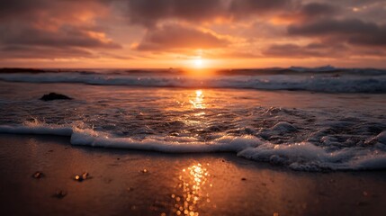 Vibrant golden sunset over the tranquil ocean with gentle waves breaking on the wet sandy beach under a colorful sky