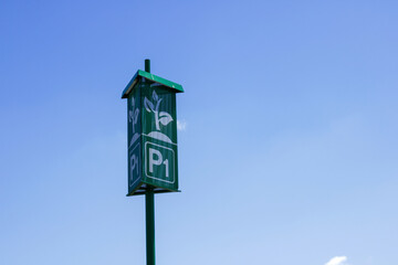 Green parking sign on metallic pillar
