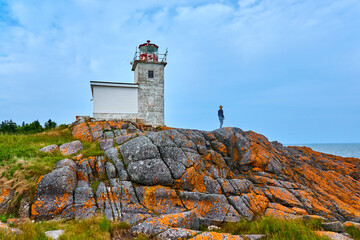 Woman sight seeing at Pea Point Lighthouse, Black's Harbor, New Brunswick, Canada. © Patrick Jennings