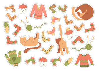 A set of stickers with a cute cats and warm clothes. Color flat illustration.