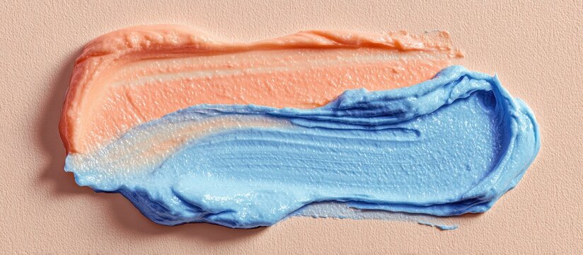 A textured swatch of two contrasting colors, a soft peach and a light periwinkle blue, applied with a brush stroke