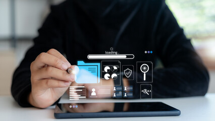 Businessman using tablet with digital hologram showing file loading, cloud storage, cybersecurity, data management, analytics, and online document processing for business technology concept.