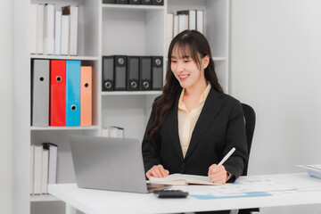 Smiling Asian Businesswoman Working at Desk