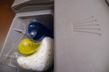 Close-up of a laundry detergent pod in a washing machine drawer.