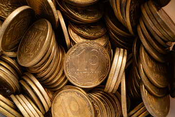 Close-up of a pile of golden Ukrainian 10 kopiyok coins.