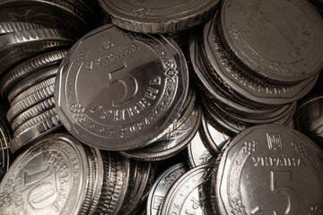Close-up of a pile of Ukrainian 5 hryvnia coins.