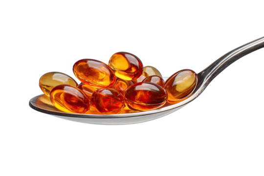 Golden capsules clustered on a spoon