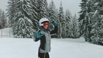 Happy woman snowboarding on ski resort snowy slope. Enjoying life, feel moment, outdoor lifestyle...
