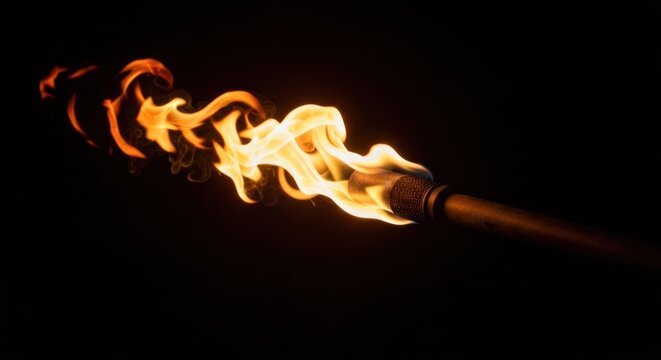 A burning torch against a black background. Flames dance and swirl around the metal torch