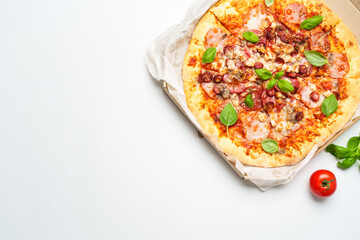 Pizza Margarita in a cardboard box on white background.