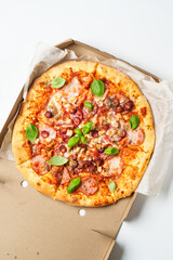 Delicious meat pizza with ham, salami and sausages.