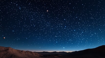 Fototapeta premium Night sky filled with stars over a mountain range with a planet visible in the distance view scene