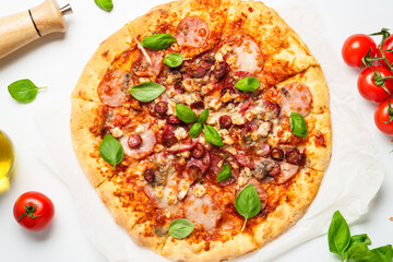 Delicious meat pizza with ham, salami and sausages.