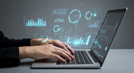 Person using laptop with floating digital data and analytics charts