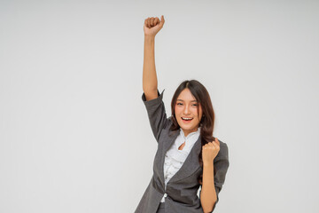 A successful professional woman happily celebrates her achievements in stylish business attire