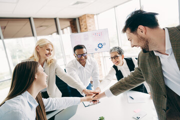 Business team members in formalwear attending a teamwork meeting in an office workspace representing collaboration and cooperation