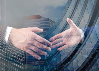 Business partners shaking hands against office buildings, double exposure. Deal, agreement,...