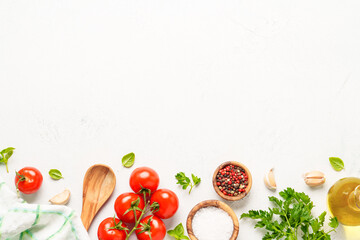 Spices, herbs and vegetables with olive oil on white kitchen table.