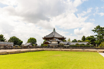 Kofuku-ji Temple in Nara, Japan with Vibrant Red and Gold Architecture under a Bright Blue Sky