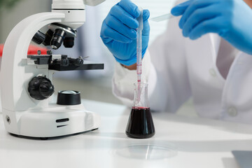 Scientist mixing chemicals in a lab experiment.