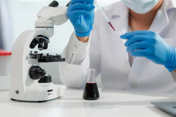 Scientist mixing chemicals in a lab experiment.