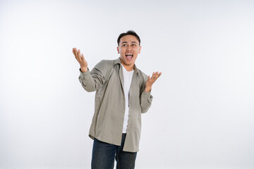 A young man joyfully expressing his emotions with dynamic gestures in a bright studio