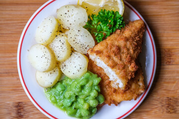  Breaded Cod Fillet With Sliced New Potatoes And Mushy Peas