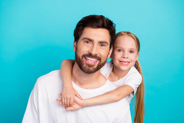 Happy father and daughter with bonding gesture on teal background embody togetherness, love, and...
