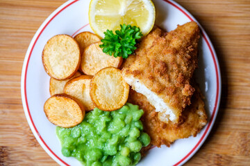 Breaded Cod Fillet With Fried Saute New Potatoes And Mushy Peas