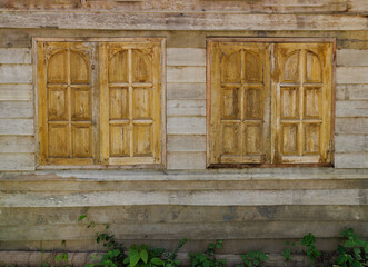 Double Traditional Brown windows with brown wood wall of traditional thailand house - vintage patterns - background