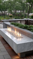 A stylish outdoor kitchen featuring a sleek countertop with a fire element, positioned in a serene garden setting filled with trees