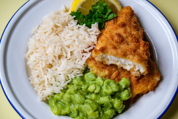 Breaded Cod Fillet With Boiled White Rice and Mushy Peas