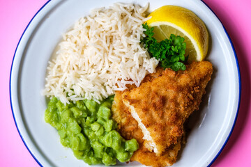 Breaded Cod Fillet With Boiled White Rice and Mushy Peas