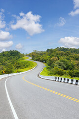 Popular view point of double s-curve road up to the hill with green tree and sky, called curve number 3 at Nan province, Northern of Thailand