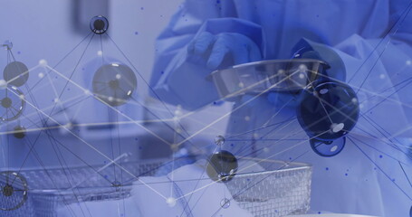 Technician wearing protective gown, blue gloves, handling bowl on lab bench, with molecular overlay