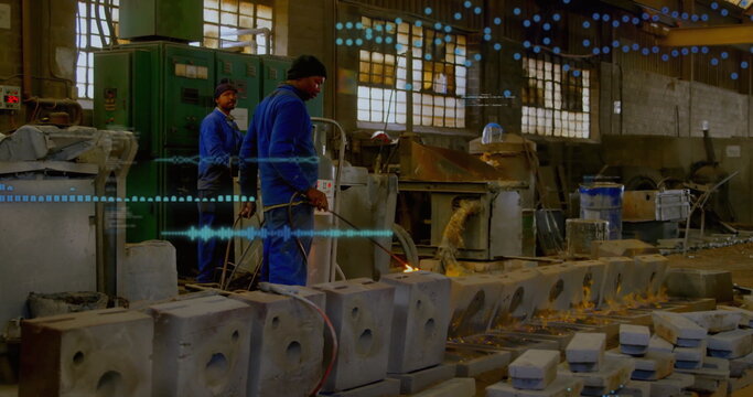 Operating gas torch worker in coveralls heating concrete molds in shop, with control panel