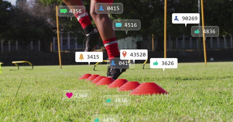 Athlete weaving in red socks and cleats on grass field, with red cones, poles, floating icons