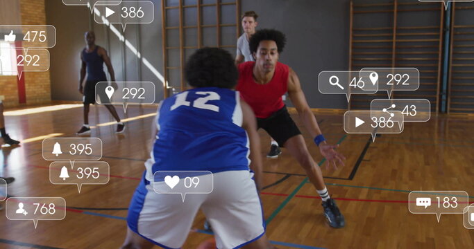 Defender in red jersey blocking dribbler on school gym court, with basketball social media icons