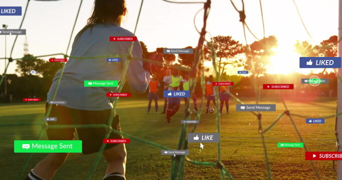 Goalkeeper stopping ball at goal net on soccer pitch at sunset, with floating notification icons - Powered by Adobe