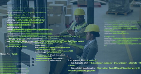 Staff wearing hard hats and safety vests checking tablet data in warehouse, with boxes and pallets