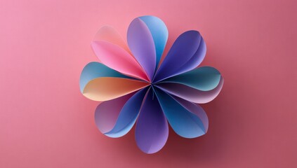 Colorful paper flower on pink background